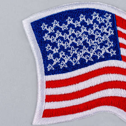 Embroidered Wavy American Flag Patch with white border close up