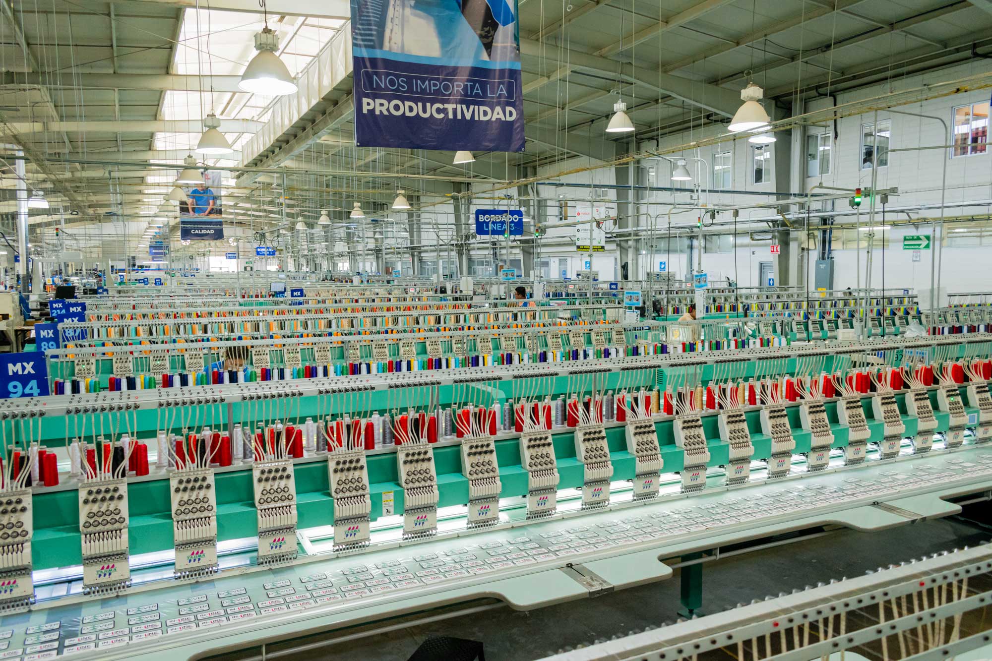 Inside view of World Emblem's patch manufacturing plant featuring embroidery machines producing custom patches at scale