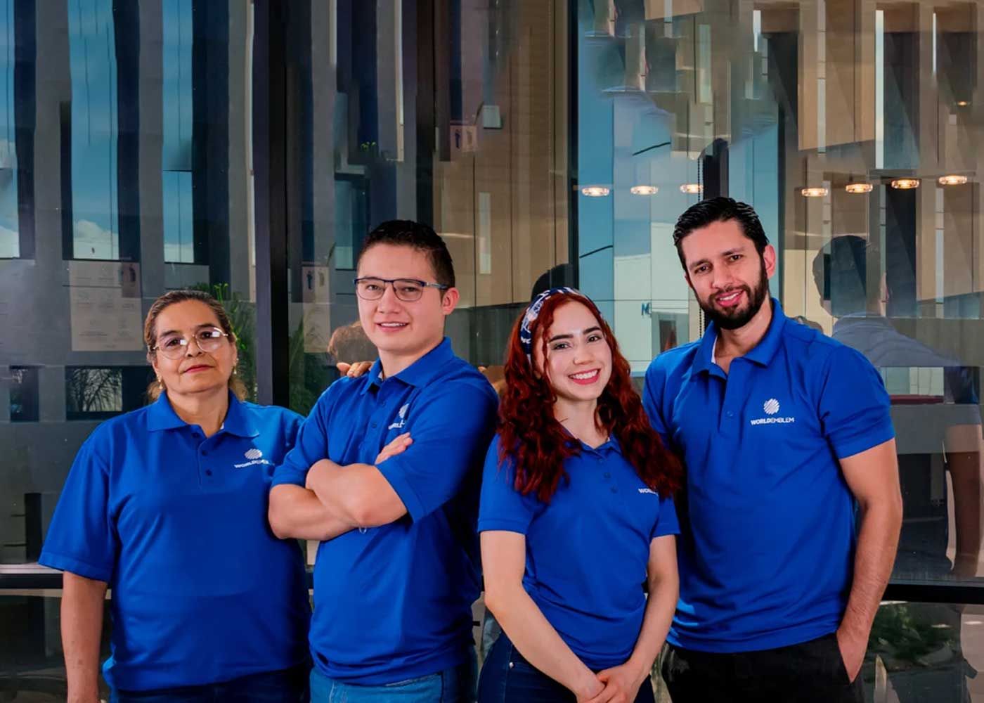 Four World Emblem team members in uniform standing together, representing expert support and custom patch design services